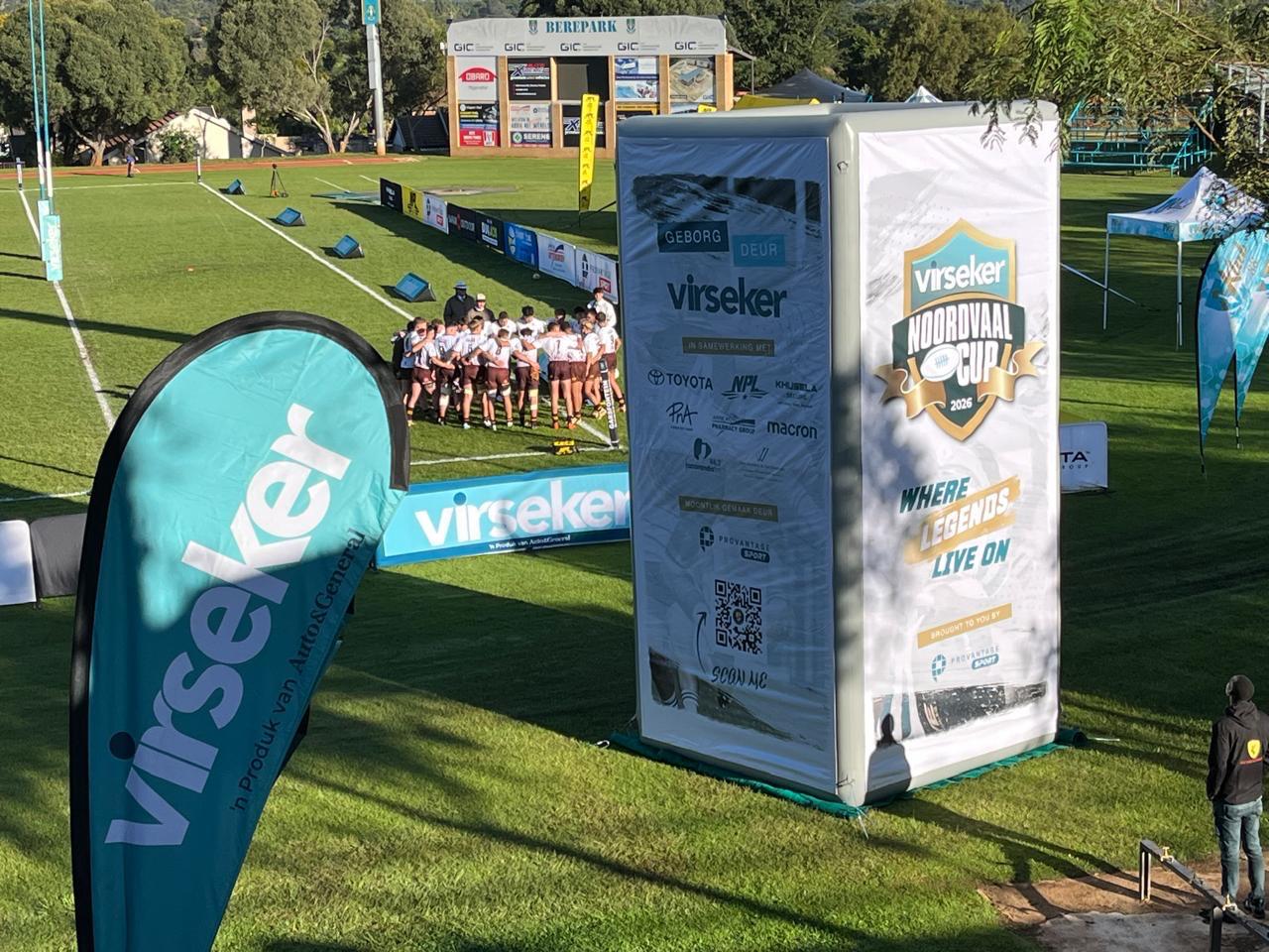Inflatable branded cube tower beside a rugby field